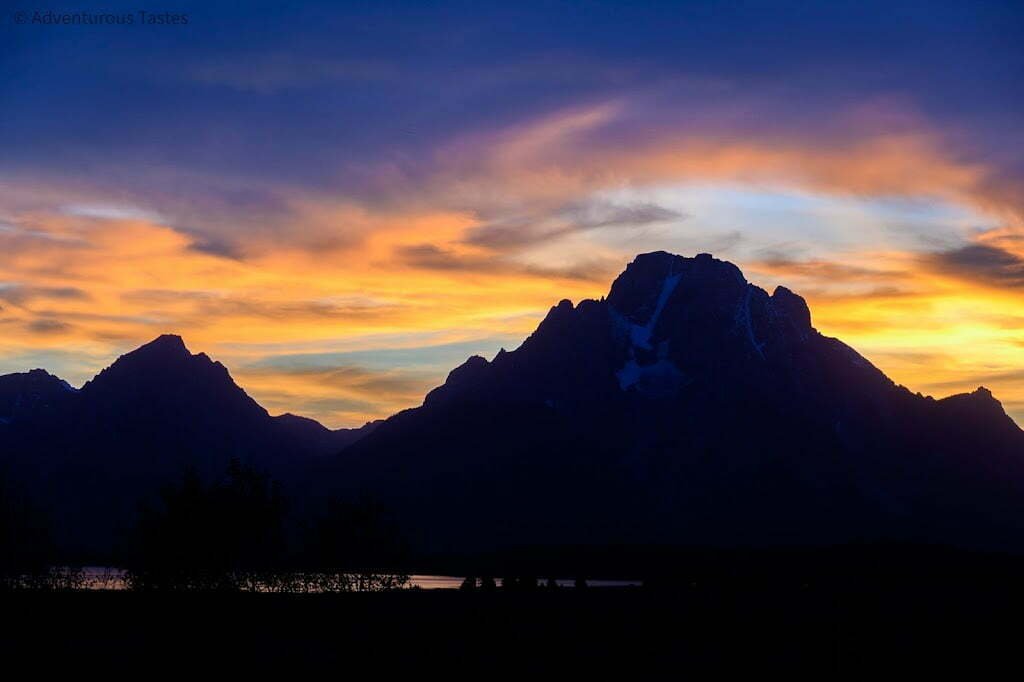 Purple and pink sunset over mountains photography spots in Yellowstone and Grand Teton