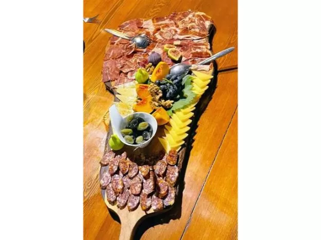 Meat and cheese on a tray appetizer during traditional Croatian peka dinner in Dubrovnik