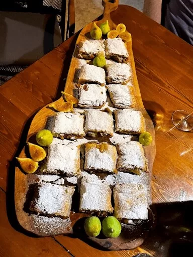 Wooden tray of fruit deserts at traditional Croatian peka dinner in Dubrovnik