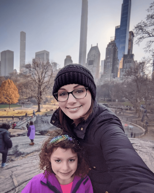 Woman and girl taking selfie in Central Park in winter