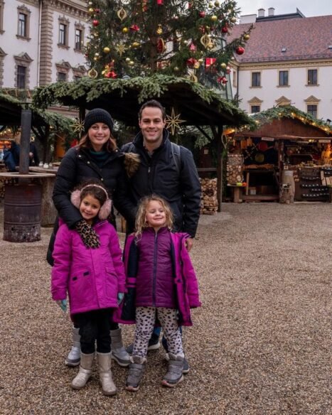 Mother, father, and two daughters pose at European Christmas Market