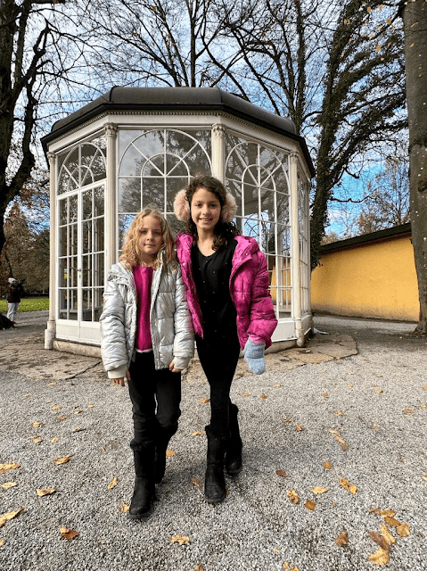 Two little girls posing in front of the gazebo in Salzburg made famous by the Sound of Music