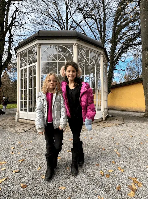 Two little girls posing in front of the gazebo in Salzburg made famous by the Sound of Music