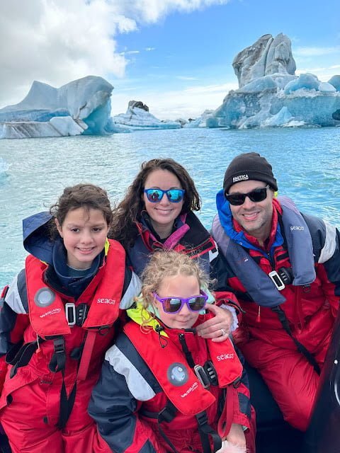 Mother, father, and two daughters dressed for a boat ride in glacier lagoon in Iceland