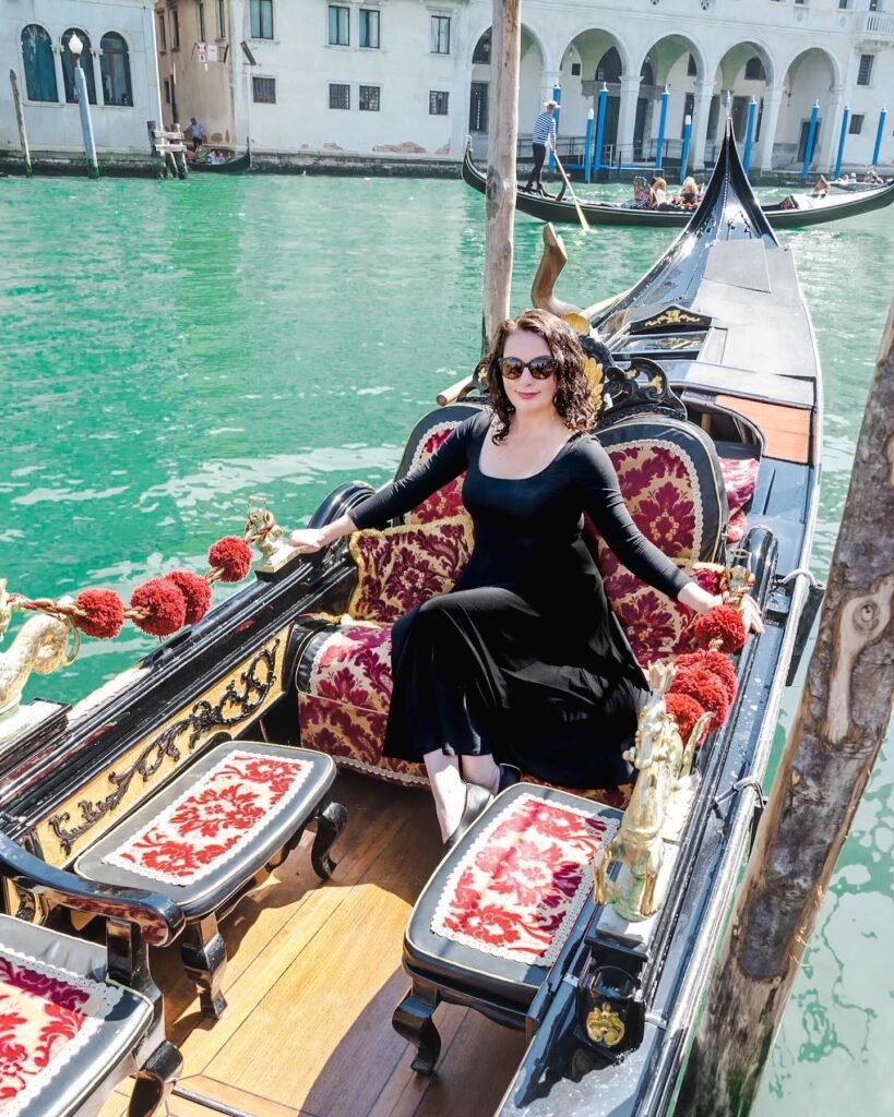 Lindsey from Adventurous Tastes posing in a gondola in Venice