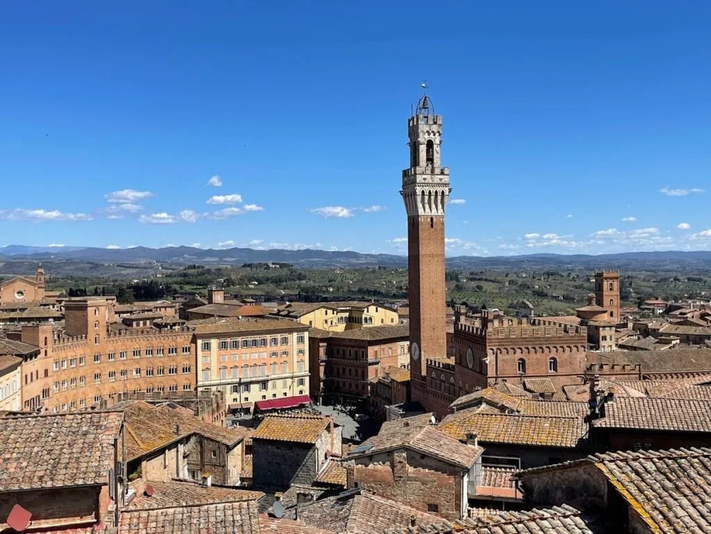 Siena is a top destination to visit in Tuscany with kids. Torre de mangia and skyline in Siena, Tuscany