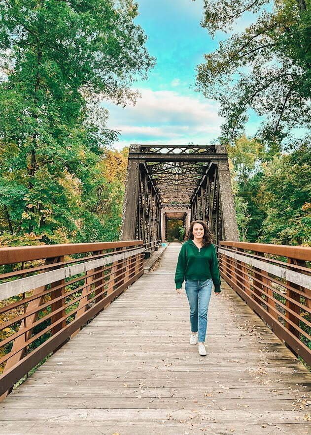 Lindsey from Adventurous Tastes walking down Springtown Bridge in New Paltz, NY, in the Catskills.