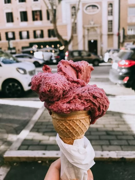 Gelato cone with Rome behind it