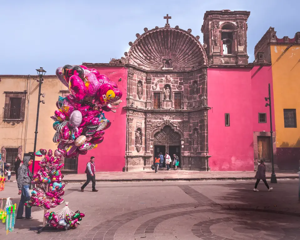 Pink walled church and mnsoan selling ball