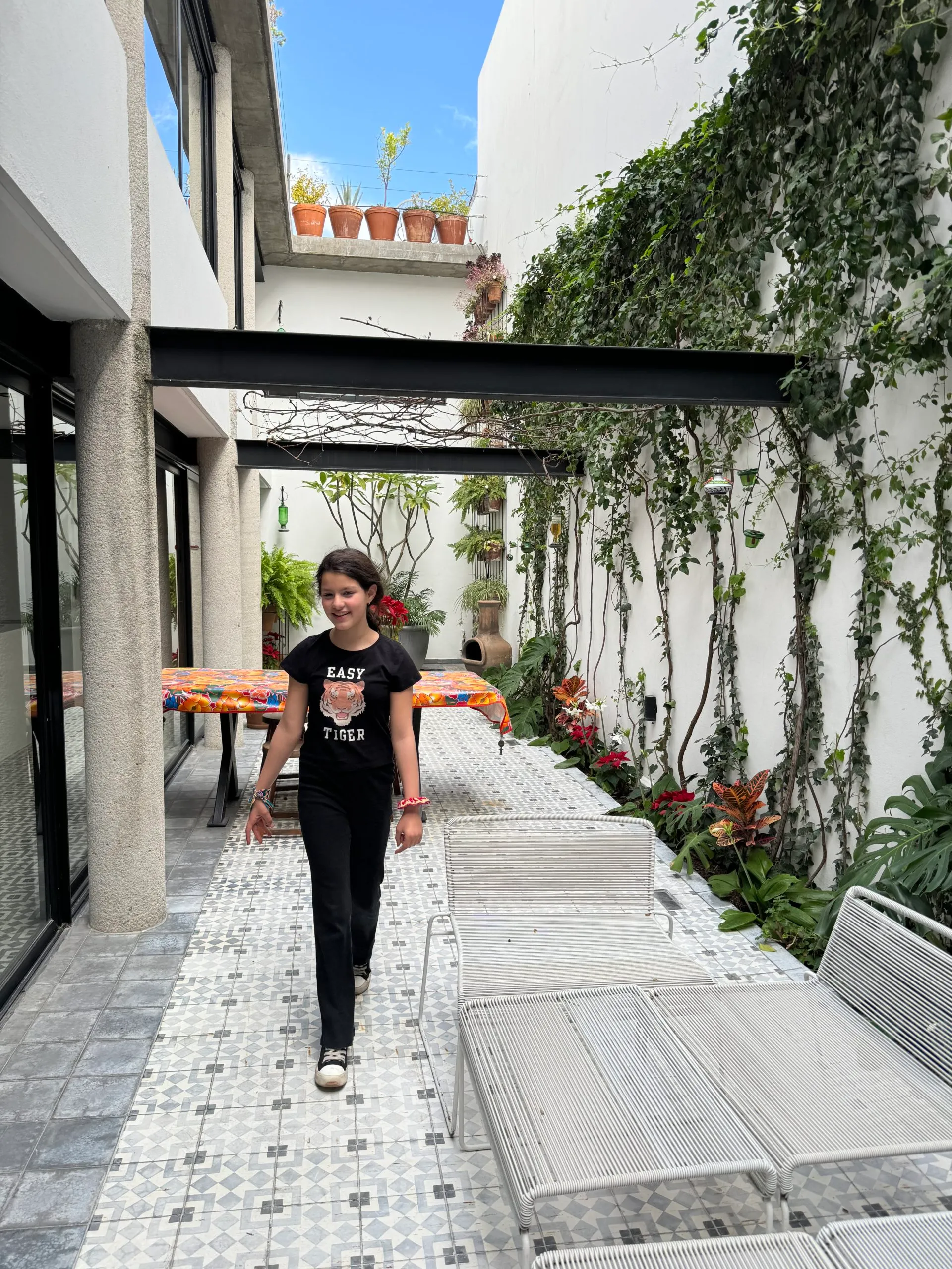 Girl from Adventurous Tastes walking on patio of her Airbnb in San Migue de Allende