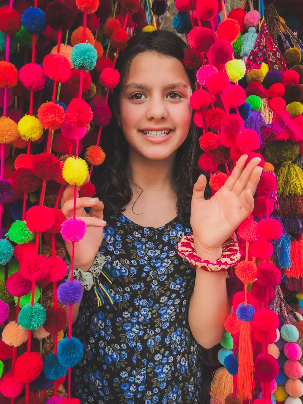 Girl shopping for crafts at Mercado de Artesanรญas in San Miguel de Allende