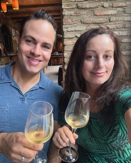 Adventurous Tastes husband and wife enjoying white wine at Pheasant's Tears in Georgia. Wine-tasting is a must for any Georgia travel guide