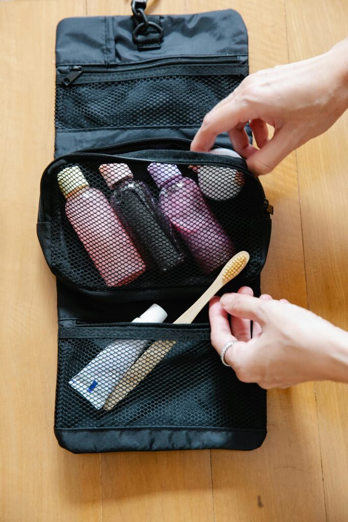 Person zipping up hanging dop kit filled with travel essentials from teh Sephora sale