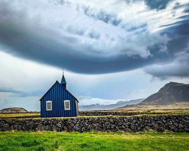 Dark church in Iceland with dramatic clouds