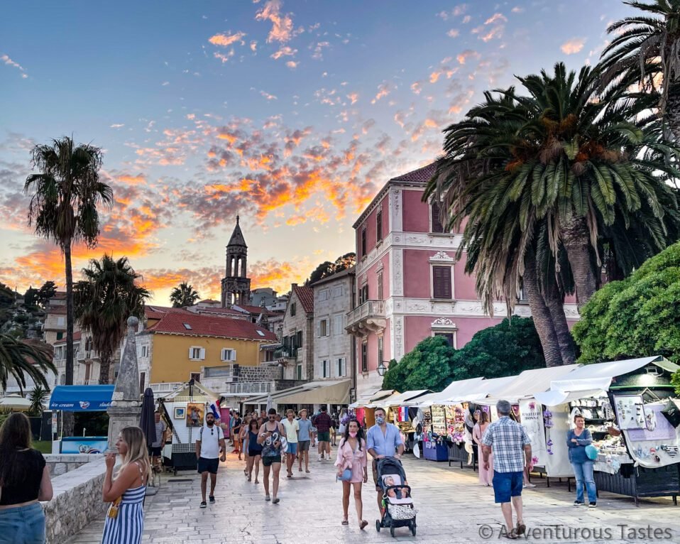 People strolling in Hvar, Croatia and sunset