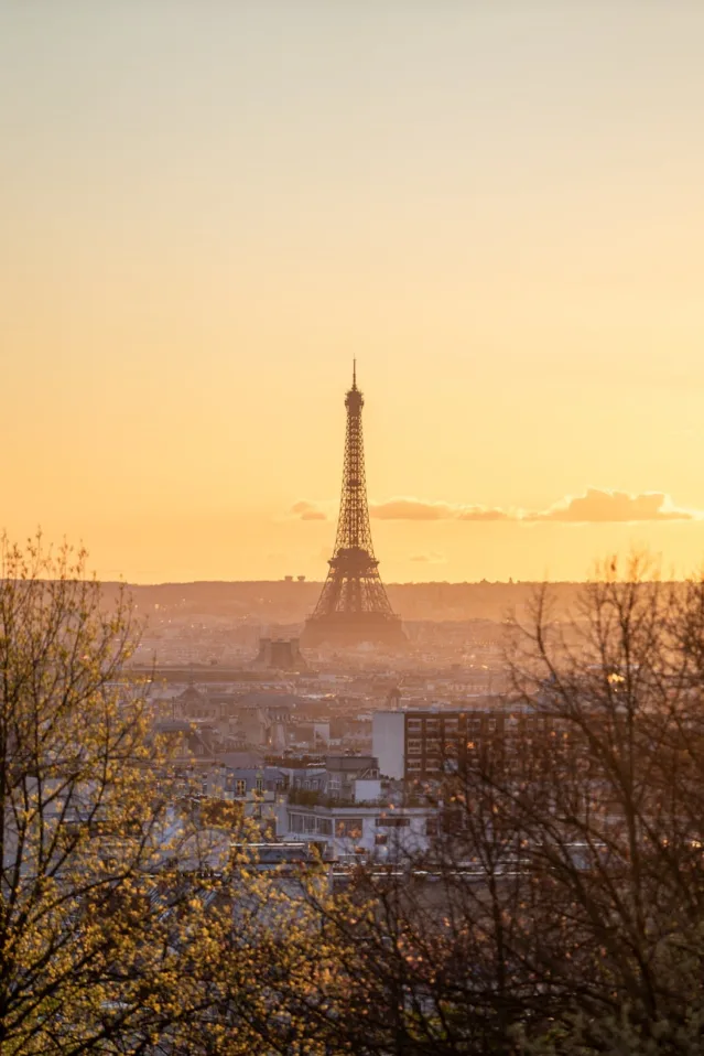 eiffel tower at sunset over paris skyline